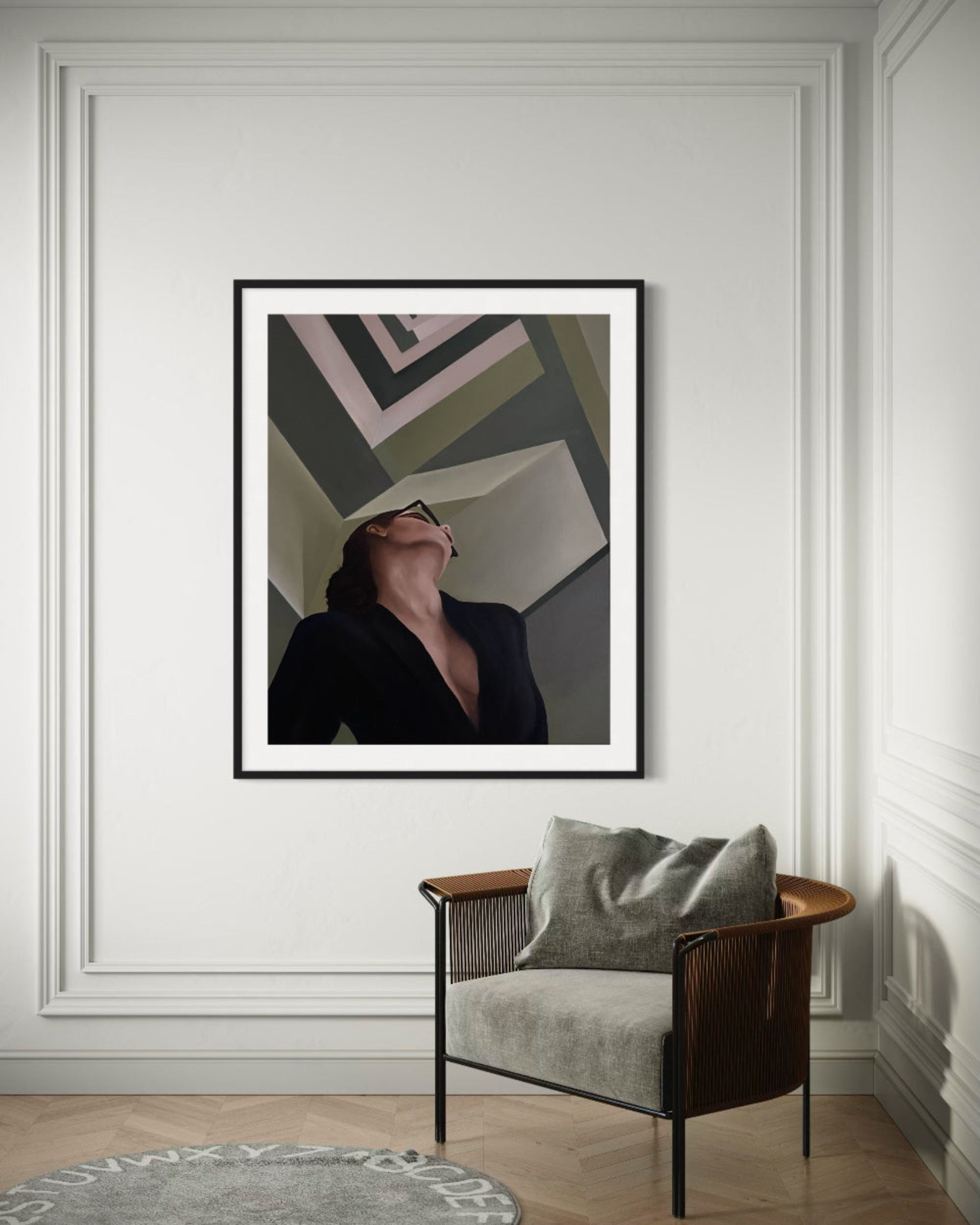 Framed abstract art on a wall above a modern chair with a gray cushion.